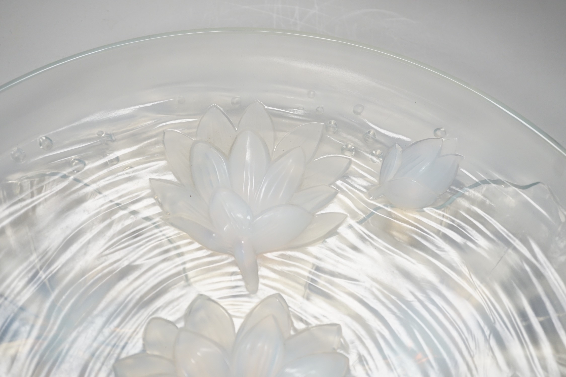 A Verlys opalescent glass dish with flower decoration. 35cm diameter